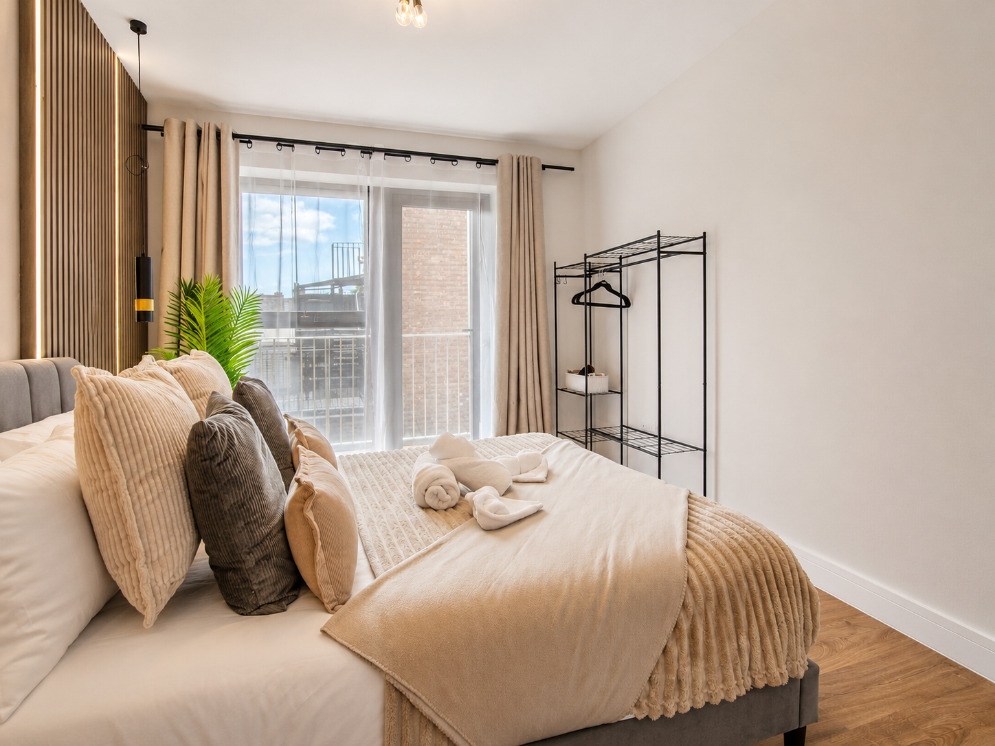Bedroom at Bromley Nest Calm with fresh linen, cushions and full-height windows