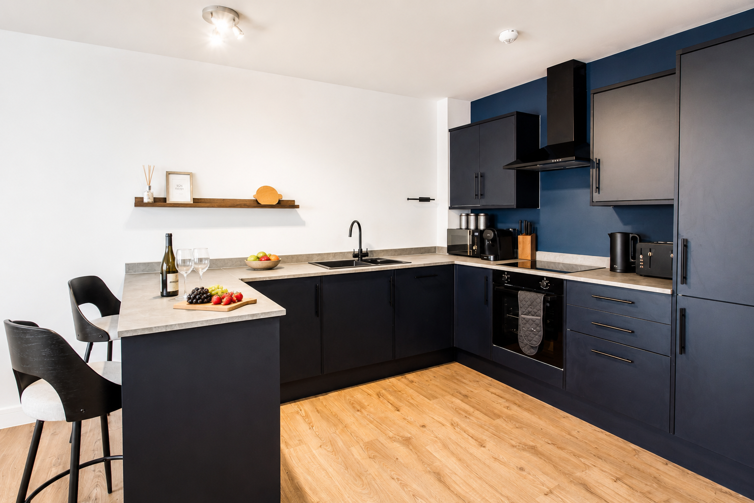 Kitchen at Bromley Nest Calm with fitted appliances and a breakfast bar
