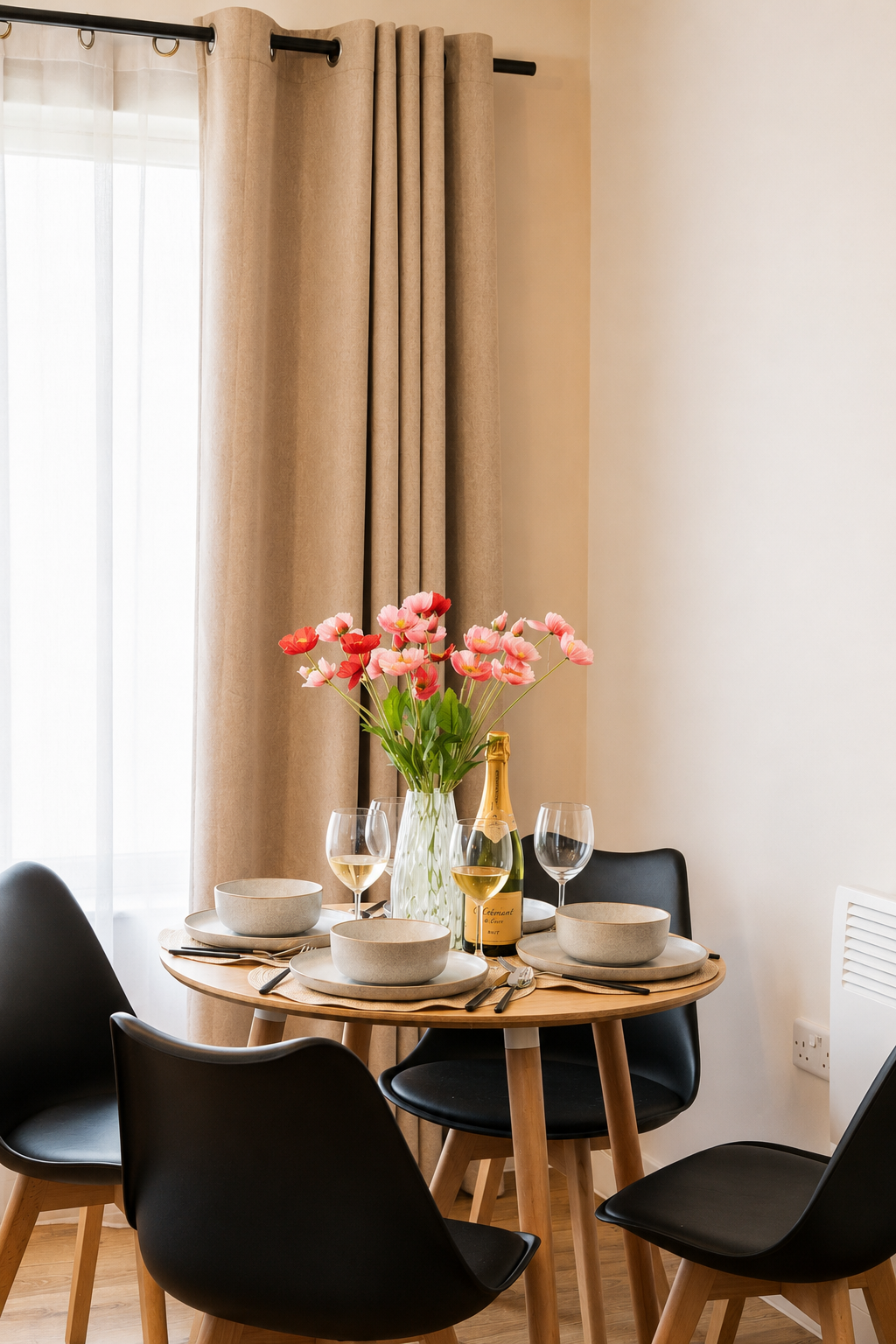 Round dining table set beside the window at Bromley Nest Calm