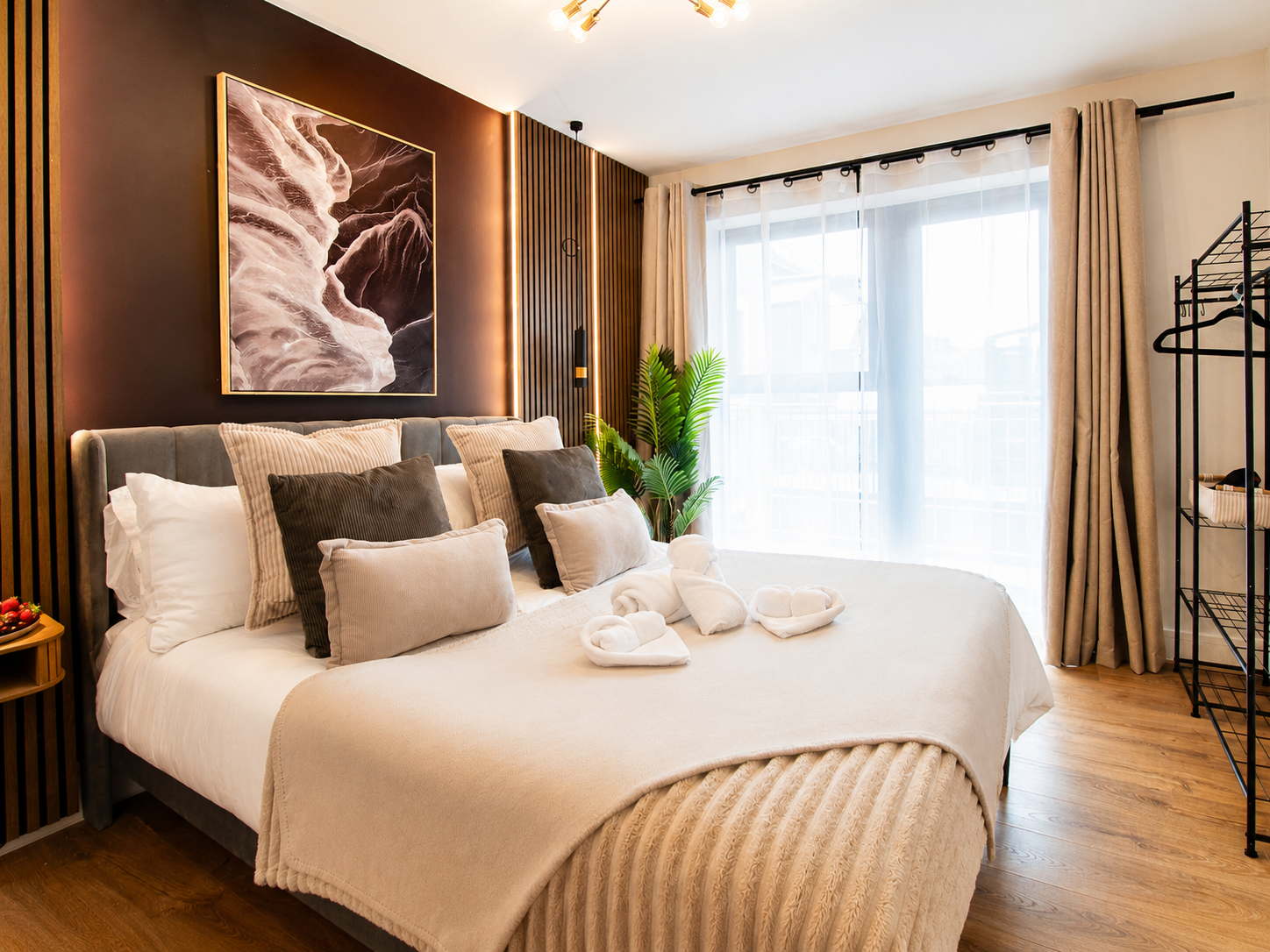 The bed with fresh linen and cushions at Bromley Nest Calm